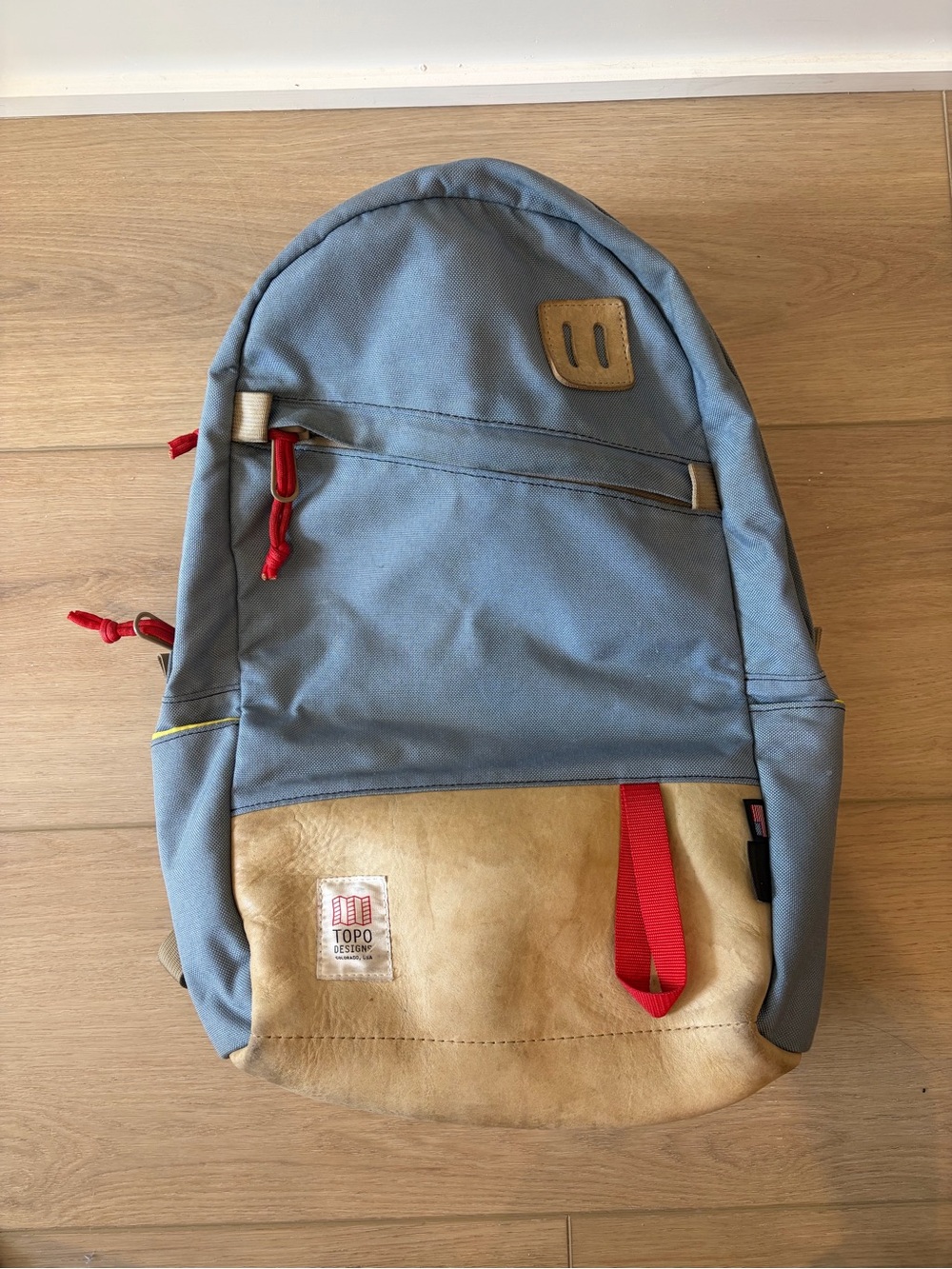 Topo Designs Light Blue Canvas Backpack with Tan Suede Base and Red Accents